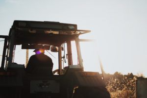 Farmer driving tractor