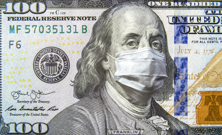 COVID-19 coronavirus in USA, 100 dollar money bill with face mask. Coronavirus affects global stock market. World economy hit by corona virus outbreak and pandemic fears. Crisis and finance concept.