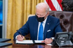 President Joe Biden signs executive orders on immigration Tuesday, Feb. 2, 2021, in the Oval Office of the White House. (Official White House Photo by Adam Schultz)