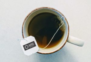 Climate Neutral logo on teabag brewing in cup