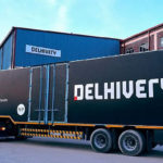 Delhivery branded lorry pulling into depot