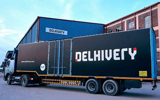 Delhivery branded lorry pulling into depot