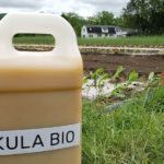 Kula Bio logo on bottle in field