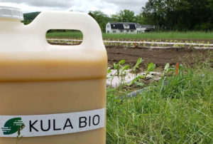 Kula Bio logo on bottle in field